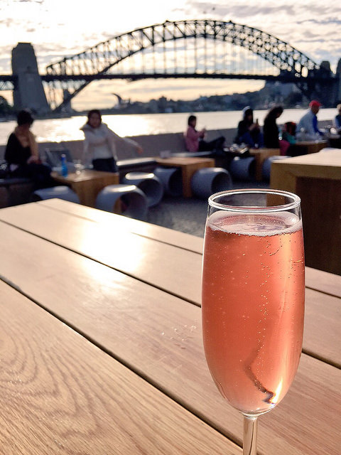 Enjoying a drink by Sydney Harbour, sparking pink moscato